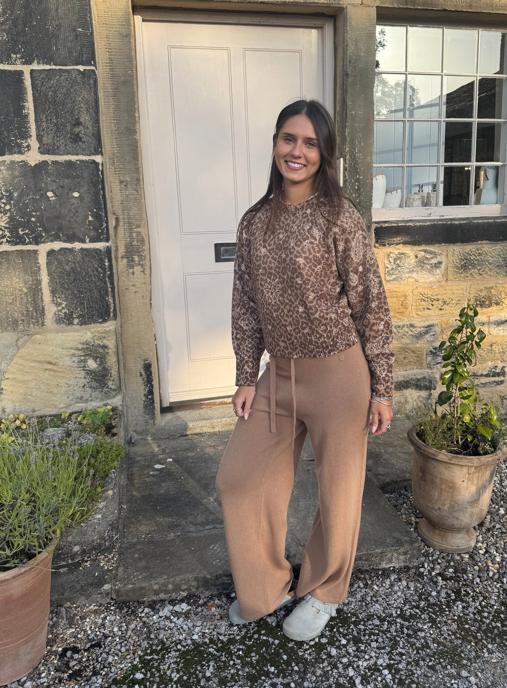 Woman wearing camel wool knit trousers with relaxed fit