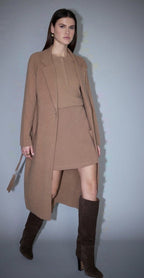 Camel wool belted coat with notch lapels, ribbed collar trim and a single-button front, worn open over a matching knit top and skirt