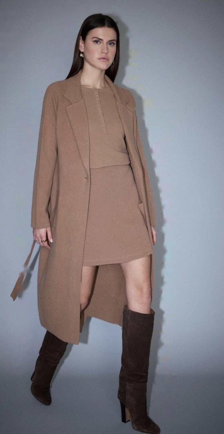 Camel wool belted coat with notch lapels, ribbed collar trim and a single-button front, worn open over a matching knit top and skirt