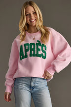 Pink Après sweatshirt with a bold varsity-style slogan, oversized fit and ribbed cuffs and hem.