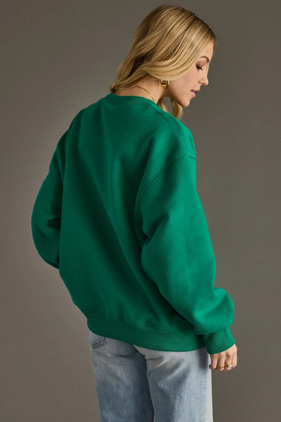 Green Ski Bum pullover with contrasting hot pink varsity lettering, soft relaxed fit and ribbed trims.