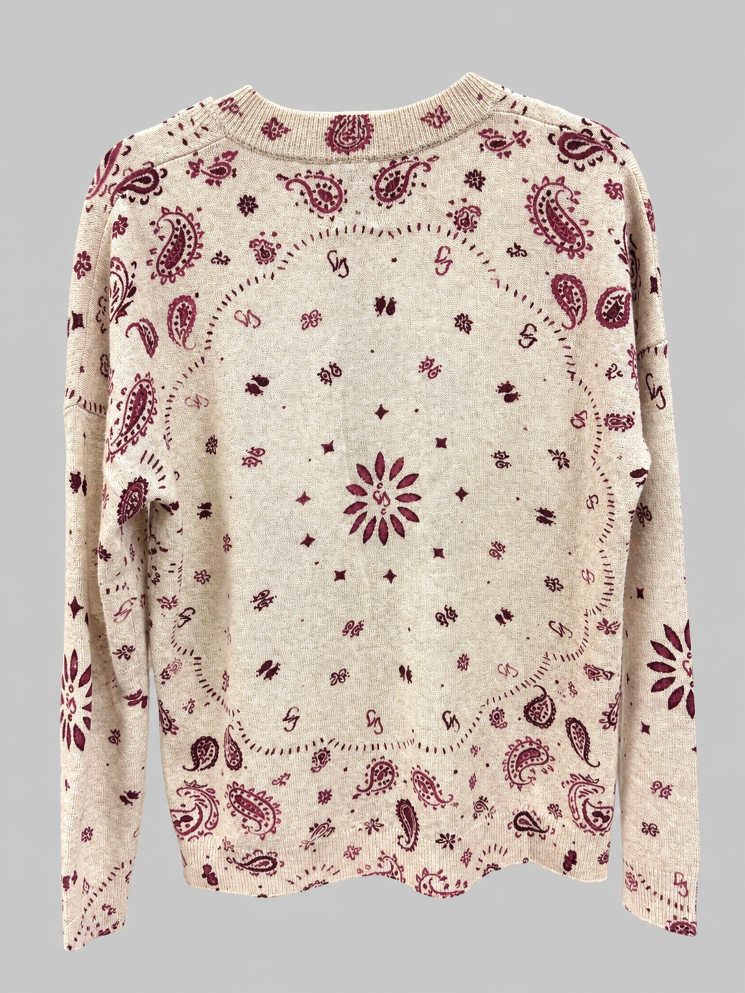 A cream-colored knit sweater with a burgundy paisley and floral bandana print, shown against a solid gray background.