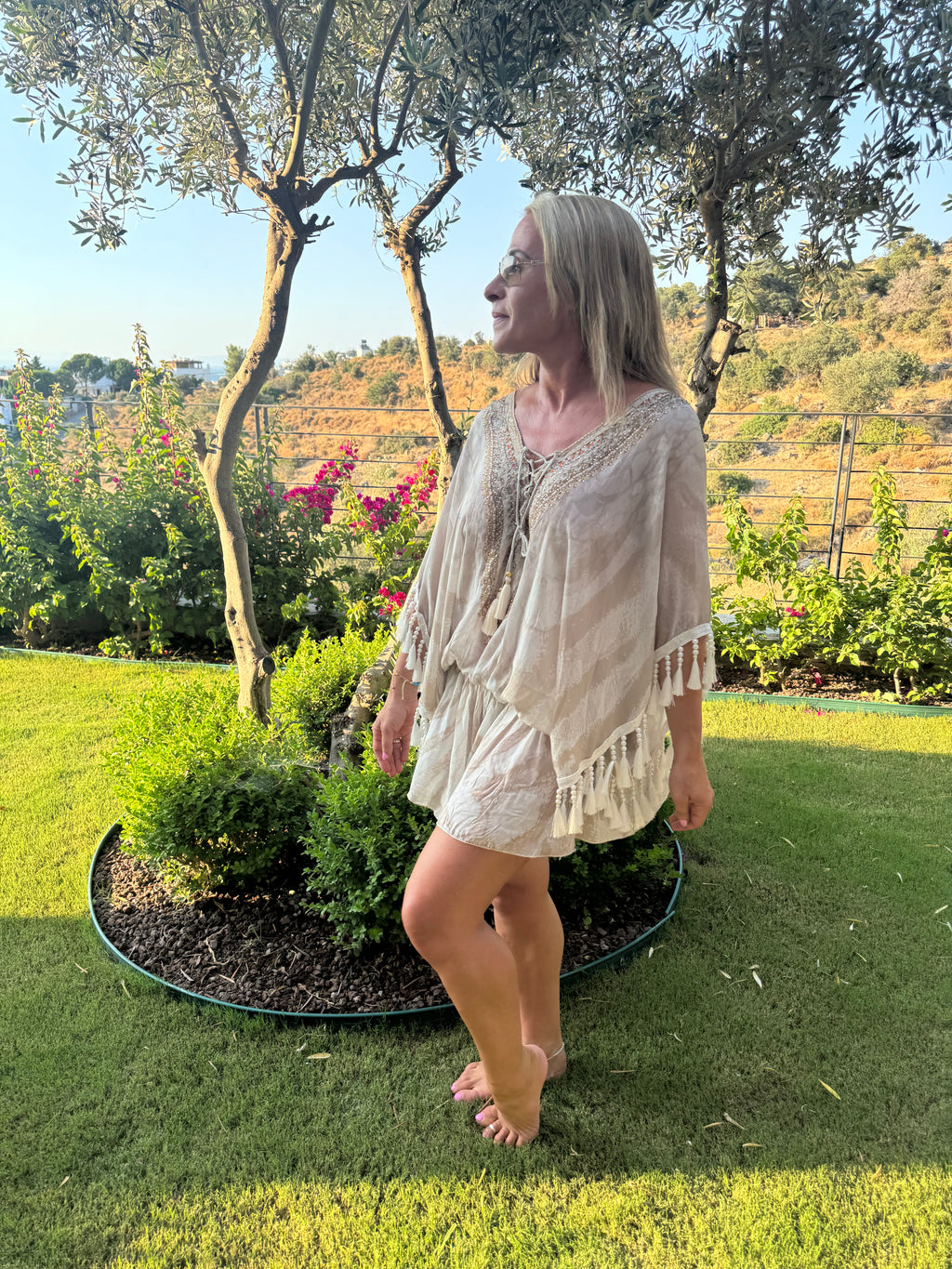 Cream holiday kaftan with a loose fit, gold-embellished V-neck, three-quarter sleeves and beaded tassel fringe.