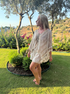 Cream holiday kaftan with a loose fit, gold-embellished V-neck, three-quarter sleeves and beaded tassel fringe.