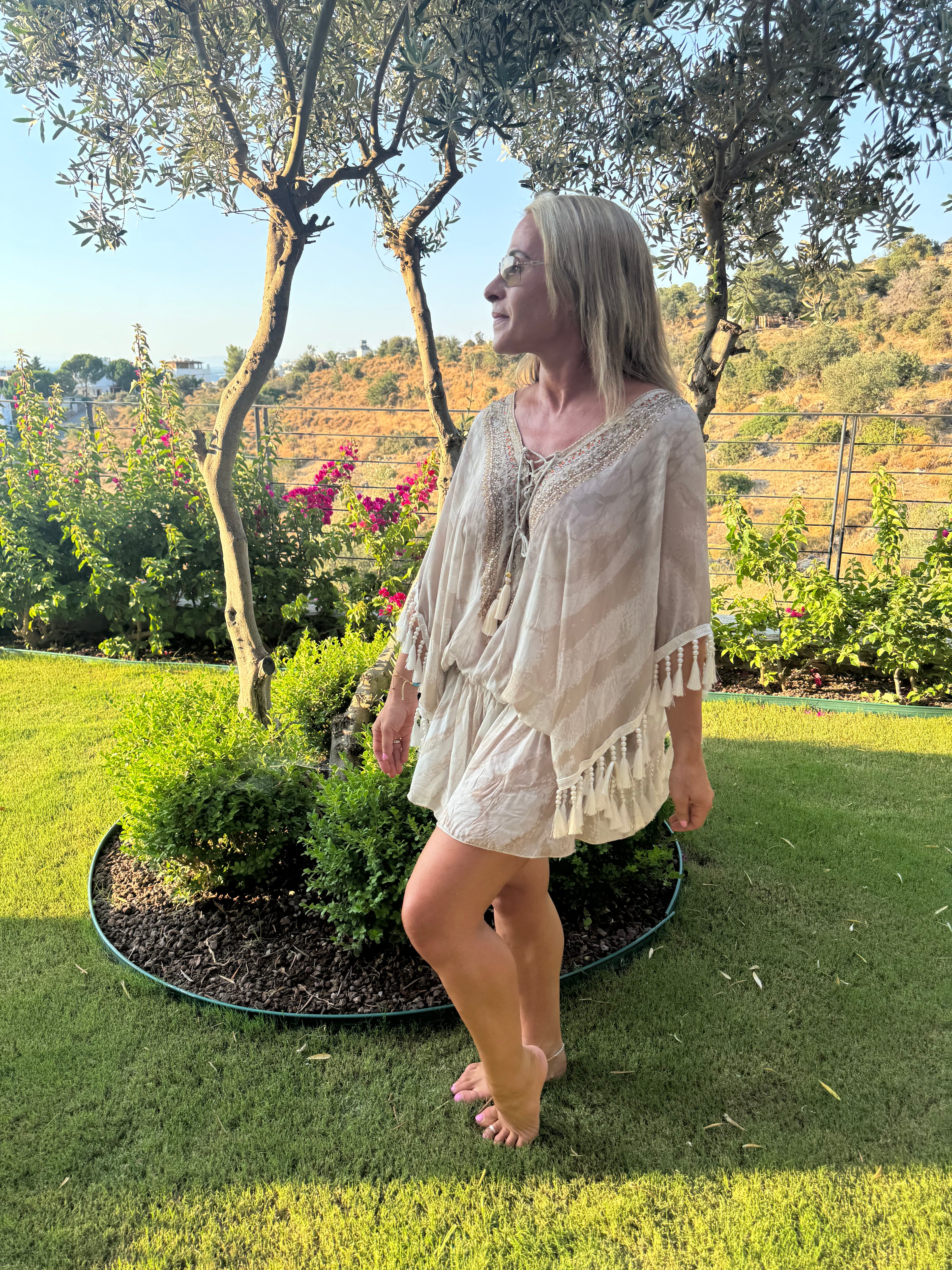 Cream holiday kaftan with a loose fit, gold-embellished V-neck, three-quarter sleeves and beaded tassel fringe.