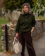 woman holding sherpa tote bag in autumn setting