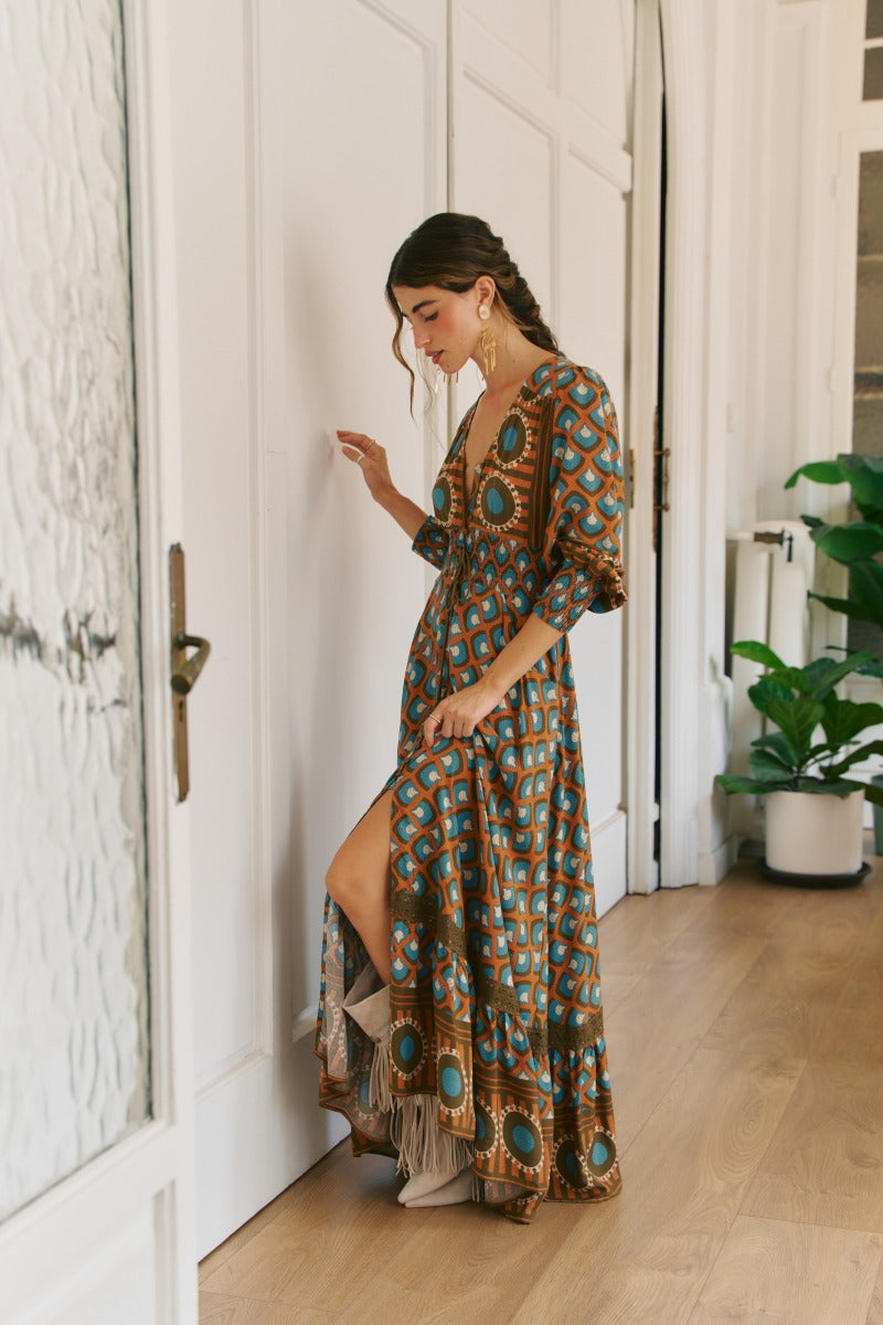 Jaase Bianca Sabrina Dress with a colourful abstract pattern, flowing maxi length and feminine high side split.